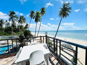 a balcony with a table and chairs and the beach at Cozy Khanom โคซี่ ขนอม in Ban Na Dan