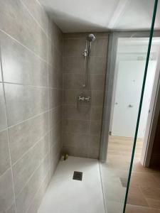 a shower with a glass door in a bathroom at More then a loft in Godella +7 photos