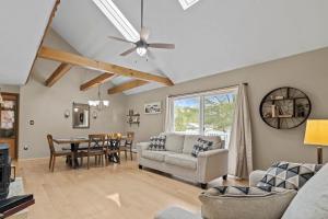 a living room with a couch and a table at 3BR Lake Luzerne Retreat with Game Room & Hot Tub in Lake Luzerne