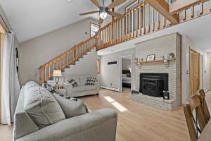a living room with a couch and a fireplace at 3BR Lake Luzerne Retreat with Game Room & Hot Tub in Lake Luzerne