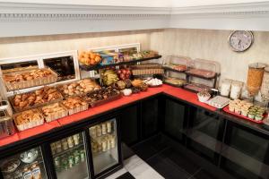 a counter filled with lots of different types of food at Royal Eagle Hotel in London +26 photos