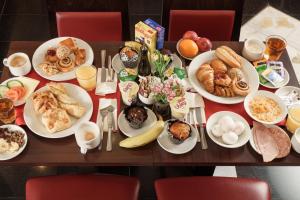 a table with plates of breakfast food on it at Royal Eagle Hotel in London