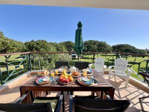 a wooden table with fruit on top of a deck at Vilamoura Sunny Garden With Pool by Homing in Vilamoura