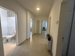 a hallway of a bathroom with a toilet and a sink at Alquiler de casa zona Córdoba Shopping in Córdoba +28 photos