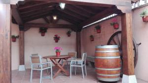 a patio with a table and a wine barrel at La Casa Madrona-Completa in Villacastín +15 photos