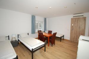 a room with a bed and a table and chairs at Letnia Oaza "Akacja" in Sobienie Jeziory