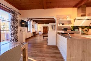a kitchen with a counter and a living room at Haus Frey in Altaussee