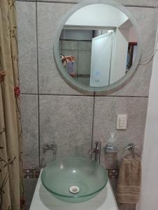 a bathroom with a green sink and a mirror at Departamento el REPOSO in Guadalajara