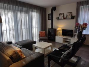 Μια τηλεόραση ή/και κέντρο ψυχαγωγίας στο 'APPARTEMENT RANDDUIN' Bed by the Sea