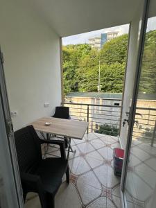 a room with a table and a balcony with a view at Marina kvariati in Kvariati +113 photos