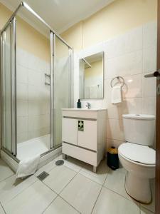 a bathroom with a shower and a toilet and a sink at Hostel Monaco in Funchal +39 photos