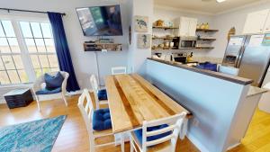 a kitchen and dining room with a wooden table at Sunset Retreat in Folly Beach
