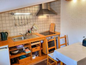 Una pequeña cocina con un fregadero y una mesa. en Ferienwohnung Wanke, en Ribnitz-Damgarten