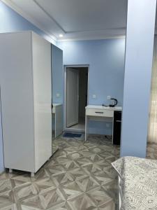an office with a blue wall and a desk at Marina kvariati in Kvariati