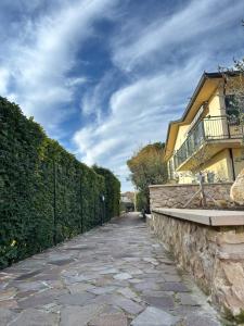 a stone path next to a fence and a building at Posticino apartment in Soave