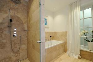 a bathroom with a shower and a bath tub at Kairem Ingiwai 22c in Keitum