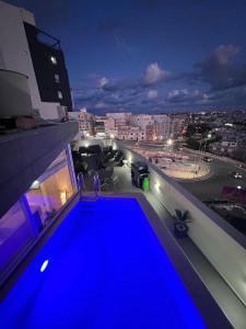 a view of a blue pool on top of a building at D Pool Top in Msida