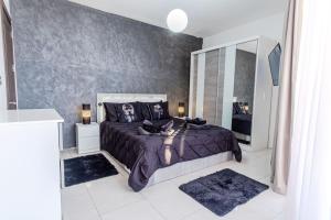 a bedroom with a large bed and a large mirror at D Pool Top in Msida +29 photos