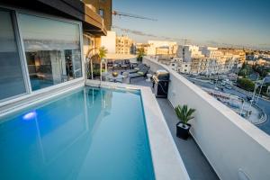 a swimming pool on the roof of a building at D Pool Top in Msida