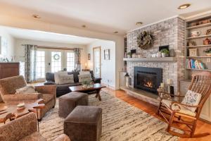 a living room with a couch and a fireplace at Quaint Elkton Home near Shenandoah National Park! in Elkton