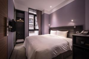 Postel nebo postele na pokoji v ubytování Yi Su Hotel-Taipei Ningxia