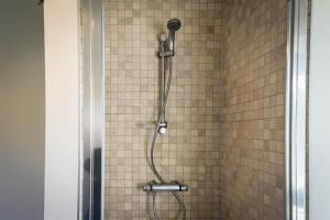 a shower with a shower head in a bathroom at Barque de Furnes in Ieper +18 photos