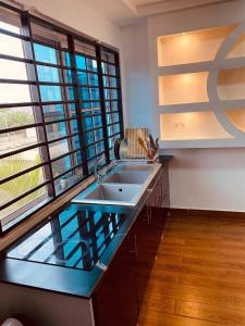 une salle de bain avec un lavabo et une grande fenêtre dans l'établissement Cozy and Big 2 Bedrooms House 5 mins to Legon Campus, à Madina