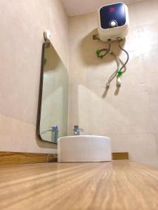 a bathroom with a sink and a camera on the wall at Cribside - Lekki Phase 1, Lagos in Ilado