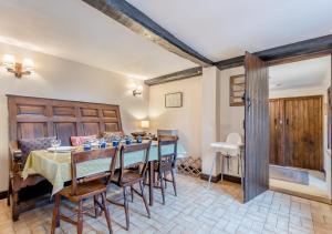 a dining room with a table and chairs and a couch at Ramblers Rest in Yarpole