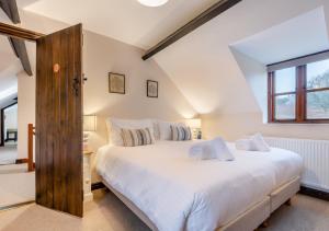 a bedroom with a large white bed and a window at Ramblers Rest in Yarpole