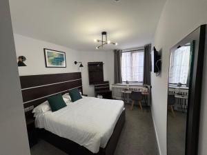 a bedroom with a bed and a desk in it at Best Western Ebbw Vale in Ebbw Vale