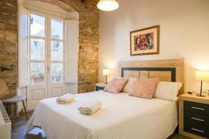 Postel nebo postele na pokoji v ubytování Ganganell Centre Apartamento con Patio