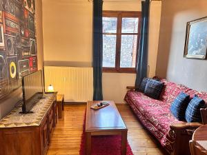 a living room with a couch and a table at Grandma's place in Arachova