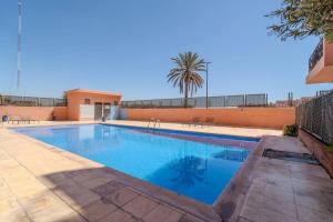 a swimming pool with blue water in a yard at Majorelle Apartment 1- Bedroom 1-Terrace Centre in Marrakech