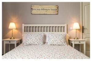 a bedroom with a white bed with two night stands at Hi Valencia Canovas in Valencia