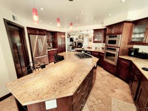 a large kitchen with wooden cabinets and a large island at Candlewood Creek in Paso Robles