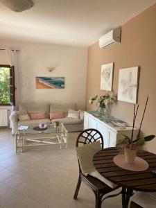 a living room with a table and a couch at La Villetta in San Teodoro