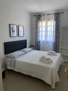 a bedroom with a bed with two towels on it at La Villetta in San Teodoro