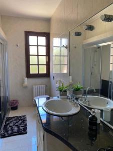 a bathroom with two sinks and a large mirror at La Villetta in San Teodoro