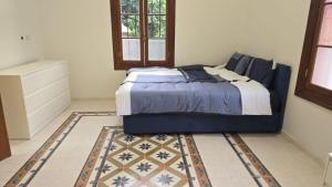 a bedroom with a bed and a rug at Ja guest house in Tel Aviv