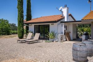 a patio with two chairs and a house at Cocavin Carriage House in Paso Robles