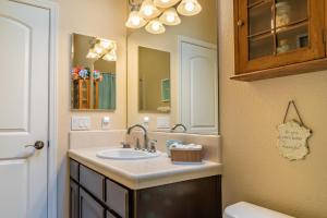 a bathroom with a sink and a mirror at Ritz Del Rio in Paso Robles +33 photos
