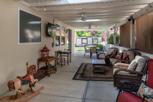 a living room with couches and a tv on the wall at Ritz Del Rio in Paso Robles