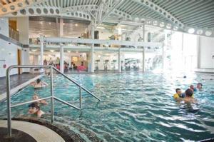 a group of people swimming in a swimming pool at 11 Borwick Lakes in Carnforth