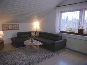 a living room with a couch and a table at Haus Deutsch Berg-See- und Schloss Neuschwanstein Nähe in Roßhaupten