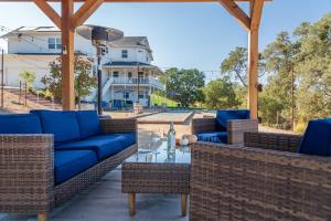 a patio with blue couches and a glass table at Graceful Oaks in Paso Robles