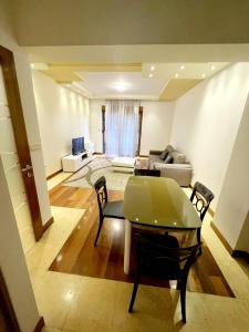 a living room with a table and a couch at City center apartment in Podgorica