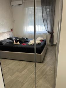 a bedroom with a bed and a glass wall at holiday home Un posto solare in Naples