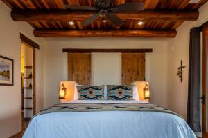 a bedroom with a bed with a ceiling fan at Renata's Retreat in Templeton +55 photos