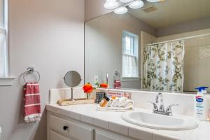 a bathroom with a sink and a mirror at Vista Vine Cottage in San Miguel +37 photos